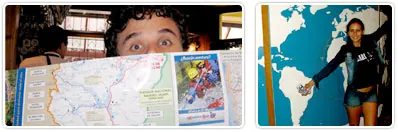 Peeking over a road map, and pointing at a world map